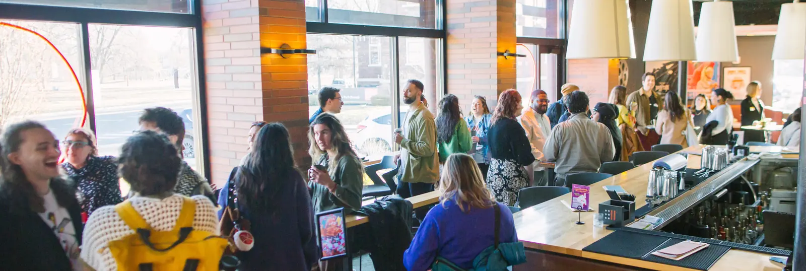 A crowded Creative Mornings gathering at the Kan-Kan bar